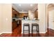 Eat-in kitchen boasts granite counters, hardwood floors, breakfast bar, and wood cabinetry at 4732 Altha St, Raleigh, NC 27606