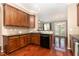 The kitchen features wood cabinets, black appliances, hardwood floors and granite counters at 4732 Altha St, Raleigh, NC 27606