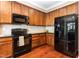 Gourmet kitchen with stainless steel appliances, hardwood floors, and granite countertops at 4732 Altha St, Raleigh, NC 27606