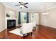 Bright living room with a fireplace, hardwood floors, modern fan and lots of light at 4732 Altha St, Raleigh, NC 27606