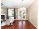 Bright living room featuring fireplace, hardwood floors, a modern chandelier and a door to the outside at 4732 Altha St, Raleigh, NC 27606