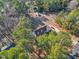 Picturesque aerial view of home surrounded by mature trees, a long driveway, and private setting at 506 Tirzah Dr, Lillington, NC 27546