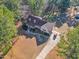 Lush aerial view showcases the charming home with firepit, long driveway, and picturesque surroundings at 506 Tirzah Dr, Lillington, NC 27546