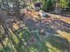 Large lot with mature trees featuring a fire pit and detached garage at 506 Tirzah Dr, Lillington, NC 27546
