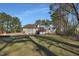 Spacious backyard showcasing the home's exterior, deck, patio, and outdoor fire pit at 506 Tirzah Dr, Lillington, NC 27546