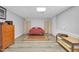 Finished basement bedroom features neutral walls, a bed, and natural light at 506 Tirzah Dr, Lillington, NC 27546