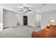 Bright and airy bonus room with a cozy couch, bookcase, and neutral carpet at 506 Tirzah Dr, Lillington, NC 27546