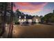 Charming yellow two-story home with dormers, a brick foundation, and a cozy front porch at 506 Tirzah Dr, Lillington, NC 27546
