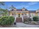 Inviting front porch with brick stairs, white railing, and stylish lights with charming landscaping at 506 Tirzah Dr, Lillington, NC 27546