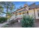 Charming front porch with blue ceiling, stylish lights, brick foundation and beautiful landscaping at 506 Tirzah Dr, Lillington, NC 27546