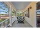 Inviting front porch with a swing and a view of the outdoors and golf course at 506 Tirzah Dr, Lillington, NC 27546