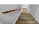 Carpeted staircase with wooden handrail leading to the next level of the home at 506 Tirzah Dr, Lillington, NC 27546