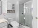 Well-lit bathroom featuring a glass-enclosed shower and cabinet with storage at 5125 Pinehall Wynd, Raleigh, NC 27604