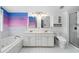 Bright bathroom featuring dual sinks, bathtub and stylish vanity at 5125 Pinehall Wynd, Raleigh, NC 27604