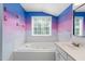 Corner tub and modern sink in a bathroom with painted colorful walls at 5125 Pinehall Wynd, Raleigh, NC 27604