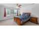 Bedroom featuring a wood frame bed, ceiling fan and two windows at 5125 Pinehall Wynd, Raleigh, NC 27604