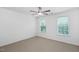 Bright bedroom featuring neutral carpet and two windows with natural light at 5125 Pinehall Wynd, Raleigh, NC 27604