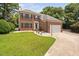 Charming two-story brick home features a manicured lawn and paved driveway at 5125 Pinehall Wynd, Raleigh, NC 27604