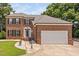 Stately brick home with manicured lawn, shutters, and attached two car garage at 5125 Pinehall Wynd, Raleigh, NC 27604
