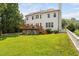 Exterior view featuring deck, white fence, and lush landscaping at 5125 Pinehall Wynd, Raleigh, NC 27604