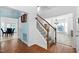 Hallway with wood floors, a staircase, and a doorway to a dining area at 5125 Pinehall Wynd, Raleigh, NC 27604