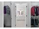 Hallway closet leading to a bathroom with dual sinks and a shower at 5125 Pinehall Wynd, Raleigh, NC 27604