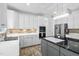 Kitchen with white cabinets, stone backsplash, stainless steel appliances, and an island with granite countertop at 5125 Pinehall Wynd, Raleigh, NC 27604