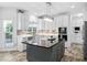 Modern kitchen with an island, stainless appliances, and stylish backsplash at 5125 Pinehall Wynd, Raleigh, NC 27604