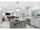 Open concept kitchen with a black island that connects to a living area and a view of the backyard at 5125 Pinehall Wynd, Raleigh, NC 27604