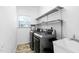Laundry room with a sink, washer, dryer, metal shelving, and a view of the backyard at 5125 Pinehall Wynd, Raleigh, NC 27604