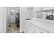 Laundry room with white cabinets, sink, mirror, and a view of the backyard at 5125 Pinehall Wynd, Raleigh, NC 27604