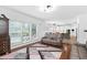 Open-concept living area with fireplace, hardwood floors, and view into bright, modern kitchen at 5125 Pinehall Wynd, Raleigh, NC 27604