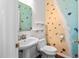 Whimsical powder room featuring unique beach-themed decor and a pedestal sink at 5125 Pinehall Wynd, Raleigh, NC 27604