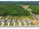 Aerial view of several homes with large yards, mature trees, and a developing area nearby at 515 Legacy Dr, Youngsville, NC 27596