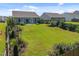 Expansive backyard showcasing a covered patio, lush landscaping, and a privacy fence at 515 Legacy Dr, Youngsville, NC 27596
