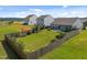 Spacious backyard featuring a covered patio area, lush landscaping, and a privacy fence at 515 Legacy Dr, Youngsville, NC 27596