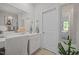 Bright bathroom vanity featuring modern fixtures, a vanity area, and a door for privacy at 515 Legacy Dr, Youngsville, NC 27596