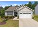 Charming single-story home with a two-car garage, well-manicured lawn, and inviting curb appeal at 515 Legacy Dr, Youngsville, NC 27596