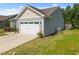 Two-car garage with a white door, side yard, and well-maintained exterior at 515 Legacy Dr, Youngsville, NC 27596