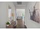 Inviting hallway featuring hardwood floors and stylish decor leading into a bright and airy living space at 515 Legacy Dr, Youngsville, NC 27596