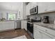 Open concept kitchen with modern appliances, white cabinets, and eat-in breakfast area at 515 Legacy Dr, Youngsville, NC 27596