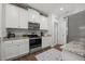 Bright kitchen features stainless steel appliances, white cabinets, and granite countertops at 515 Legacy Dr, Youngsville, NC 27596