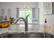 Stainless steel kitchen sink complemented by granite countertops and natural light at 515 Legacy Dr, Youngsville, NC 27596