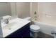 Bathroom with a white vanity, toilet, and bathtub with shower at 5908 Abbington Way, Raleigh, NC 27610