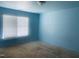 Bedroom with bare floors, light blue walls, and a window with blinds at 5908 Abbington Way, Raleigh, NC 27610