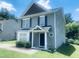 Corner view of gray home with black shutters, featuring landscaping and a Ring doorbell at 5908 Abbington Way, Raleigh, NC 27610