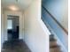 Hallway with tile floors, stairway and living room access at 5908 Abbington Way, Raleigh, NC 27610