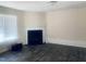 Cozy living room featuring dark wood floors and a fireplace with a white mantle at 5908 Abbington Way, Raleigh, NC 27610