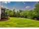 Expansive backyard features a fire pit, lush lawn, and perimeter landscaping for added privacy at 610 Bennett Mountain, Chapel Hill, NC 27516