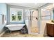 Elegant bathroom features a soaking tub, walk-in shower, and neutral colored tiles at 610 Bennett Mountain, Chapel Hill, NC 27516